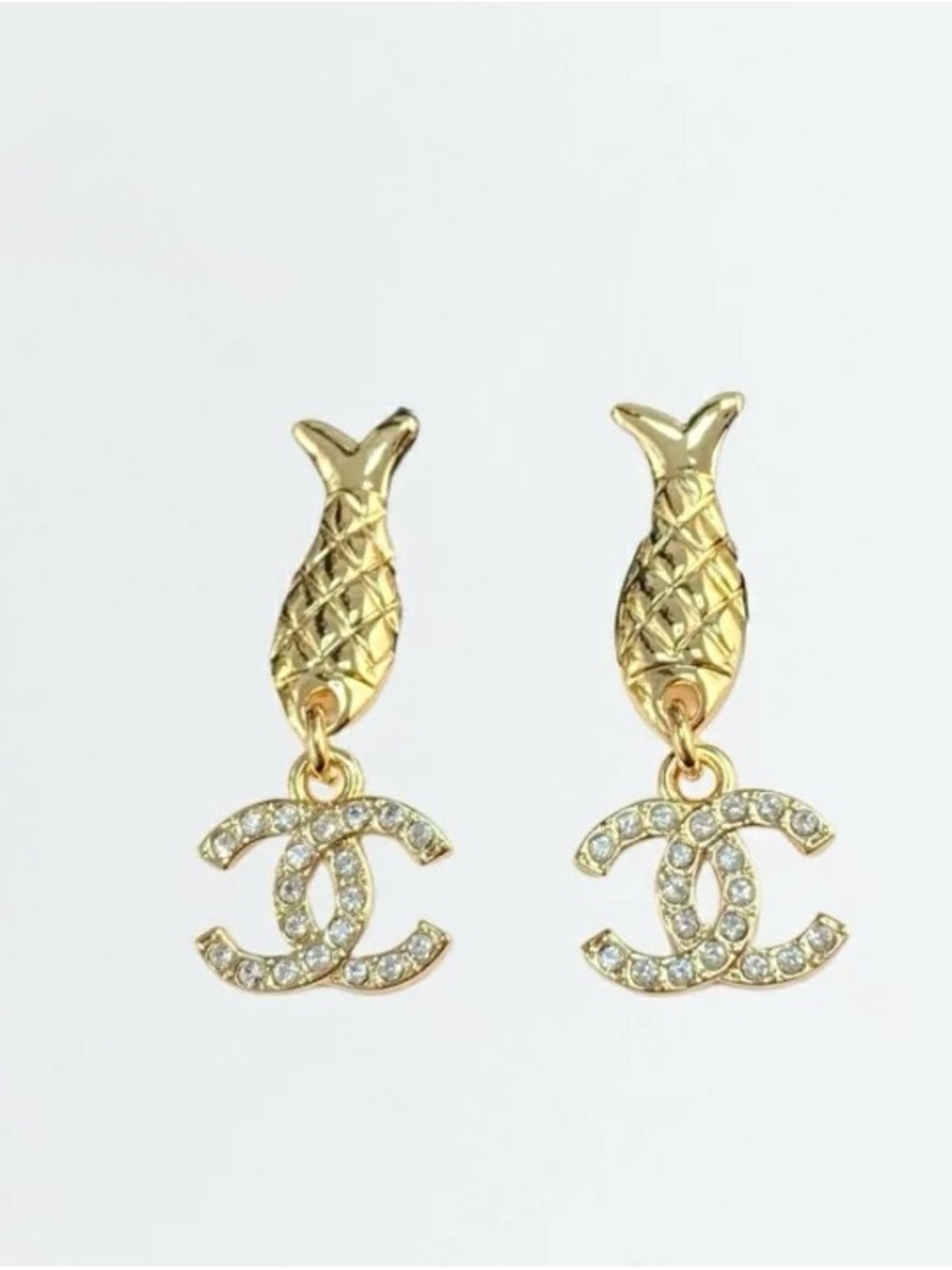 CHANEL fish motif dangling earrings fish studs and dangling rhinestone CC logos.